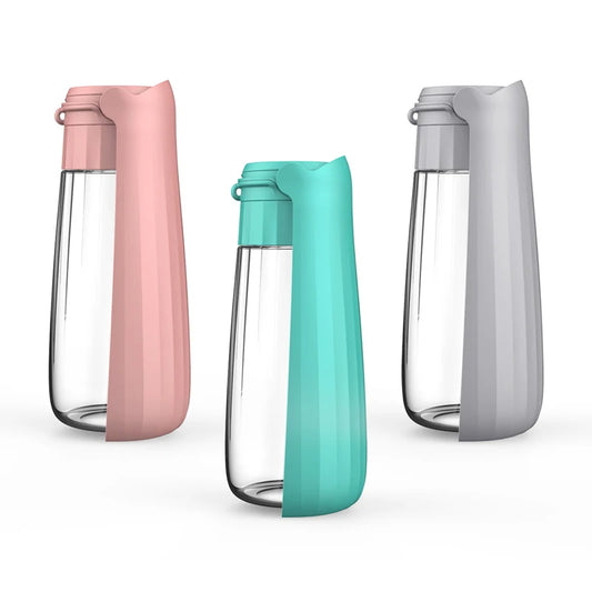 Portable pet water bottles in pink, turquoise, and grey – 550ml leakproof travel design.